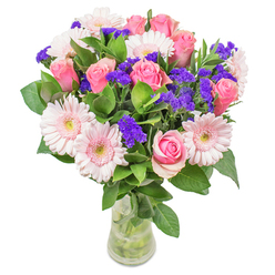 Arranged against the tranquil backdrop of Harpenden, this bouquet is a luminous celebration of gentle colour and fresh textures. The finest blush gerberas and softly blooming pink roses meet at the heart of the arrangement, their hues blending together in the way mist rises over the Common on a spring morning. Pops of deep purple statice dart between the blooms, adding uplifting contrast much like the wildflowers that enliven local gardens near Batford Springs. Cool, dewy greenery forms a supportive base, infusing the bouquet with refreshing woodland scent and abundance. Set in a simple glass vase, with each stem clearly visible, the composition feels both spirited and serene, glowing softly even in natural daylight. Designed for a range of heartfelt occasions-whether as a get-well gesture to a neighbour, a thoughtful touch for an office on Station Road, or an elegant centrepiece for a family gathering-the bouquet embodies the care and optimism Flower Delivery Harpenden brings to every creation. The attention to craftsmanship and the interplay of colour make it at once joyful, light, and utterly uplifting-ideal for sharing the unique warmth of our close-knit community.